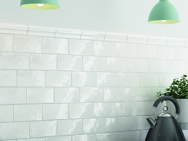 White gloss tiles which are set as a kitchen splashback